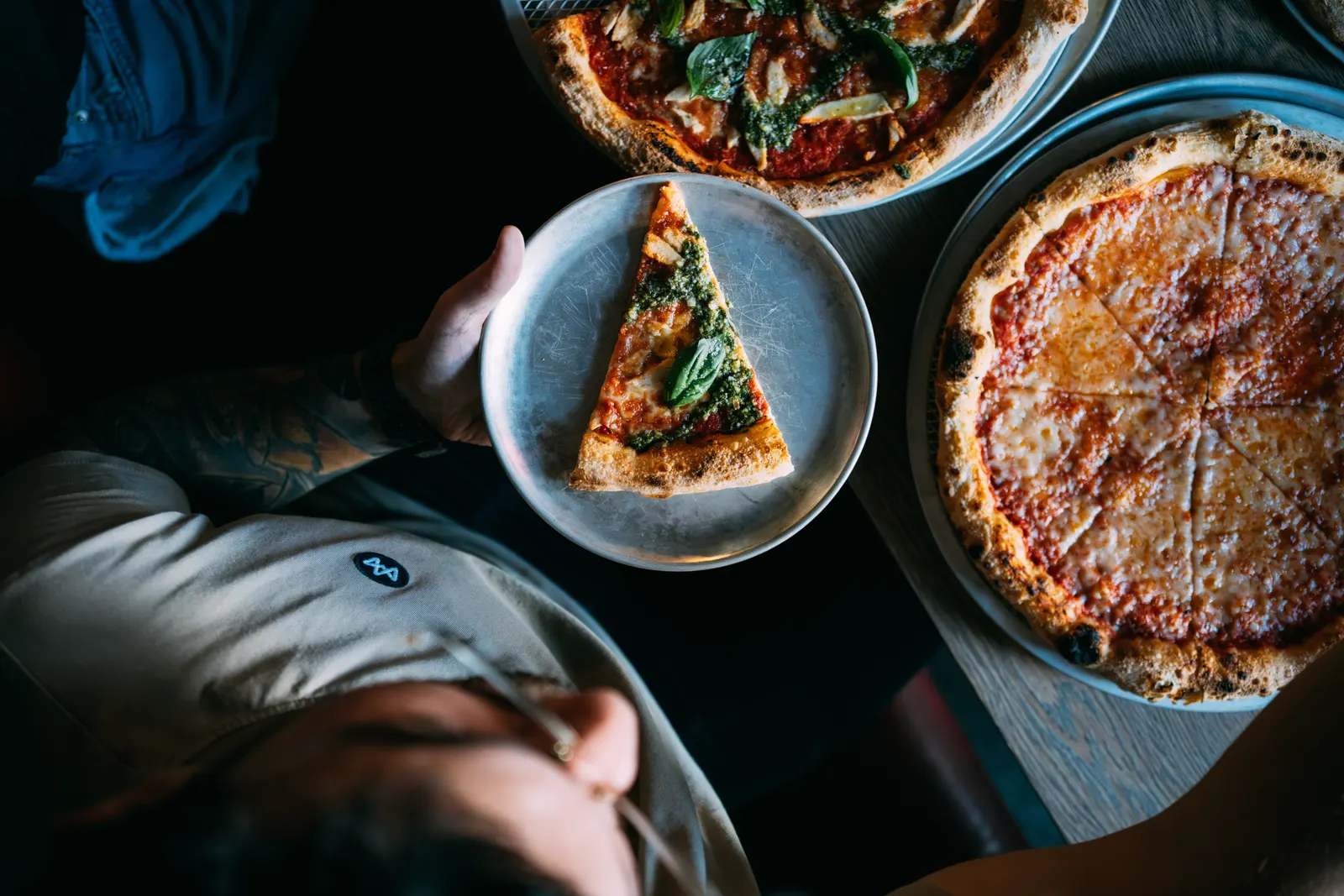 Digging into a table of Brooklyn-style pizzas at Mama Said