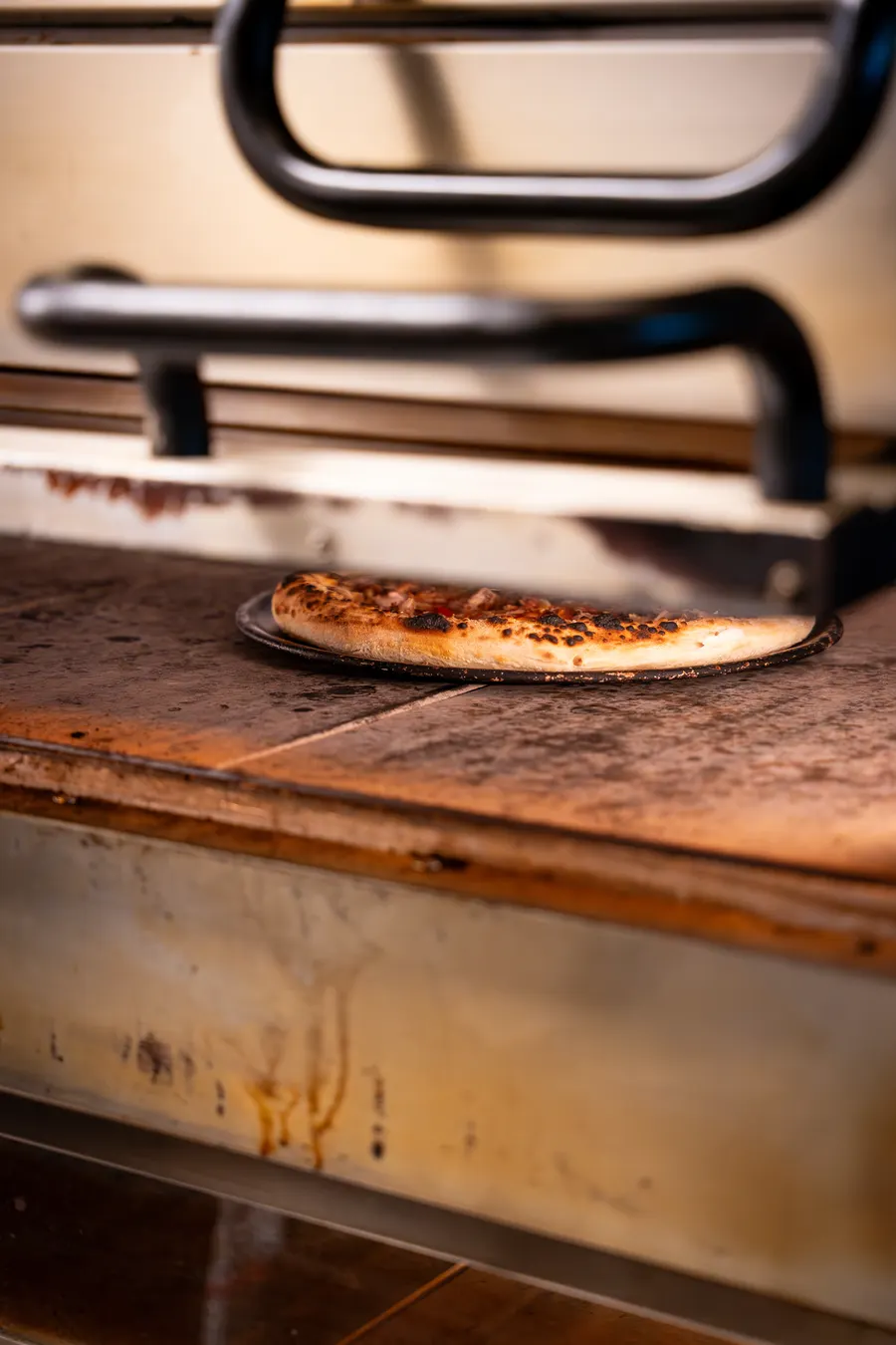 Pizza baking inside the deck oven